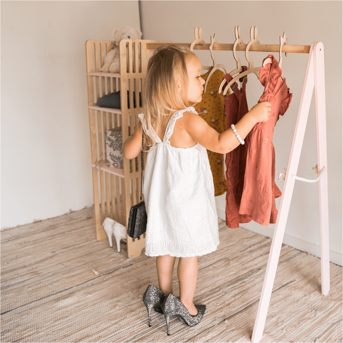 Children's Wooden Clothing Rack in Pink and Ivory White, Montessori-style design for easy kids' clothes wardrobe and access. - EWART WOODS